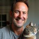 Thomas Green smiles with British Shorthair